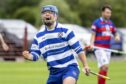 Newtonmore's Iain Robinson celebrates his hat-trick to against Kingussie.  Image: Neil Paterson.