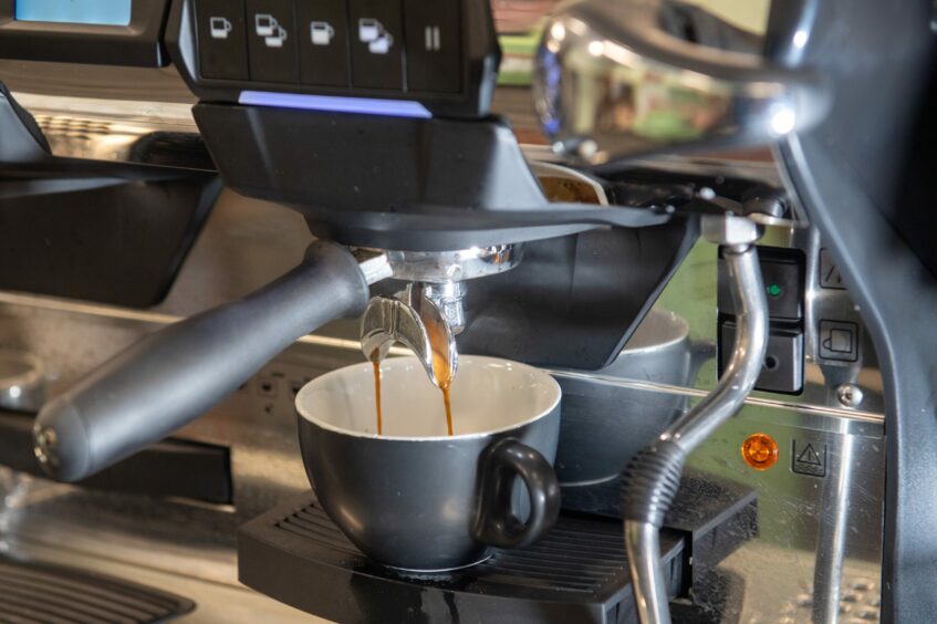 A coffee machine pouring a coffee