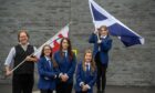 Philip Tibbetts, the Lyon Court Vexillologist for Scotland, visited Inverurie Academy as a competition to find a new Aberdeenshire flag is launched. Pupil Isla Bateman waves the Saltire with, from left, Shannon Jamieson, Iona Duncan and Neve Simpson.   Picture by Kami Thomson