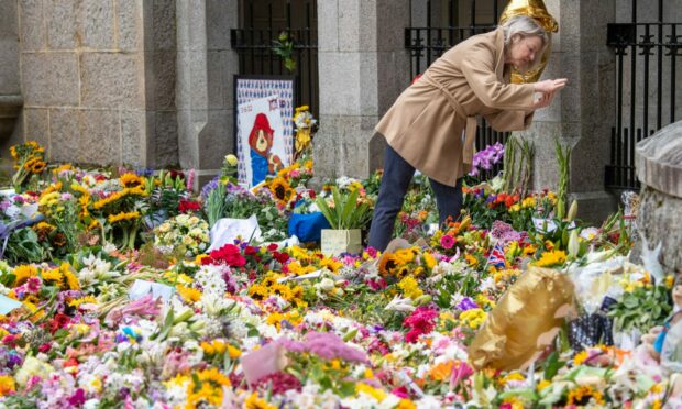 Countless flowers have been placed at the gates of Balmoral. Photo: Kami Thomson/DC Thomson