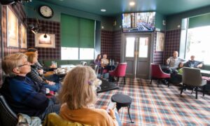 Patrons of the Balmoral Bar in Ballater watch the Queen's funeral. Picture by Kami Thomson
