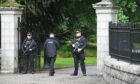 Police stand guard outside Balmoral Castle