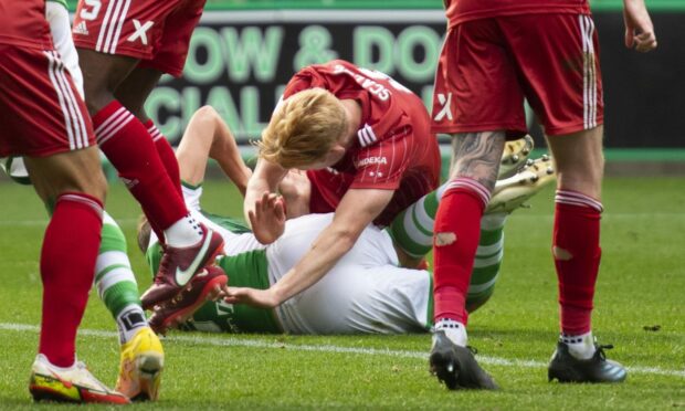 Hibernian's Ryan Porteous and Aberdeen's Liam Scales hit the deck at Easter Road.