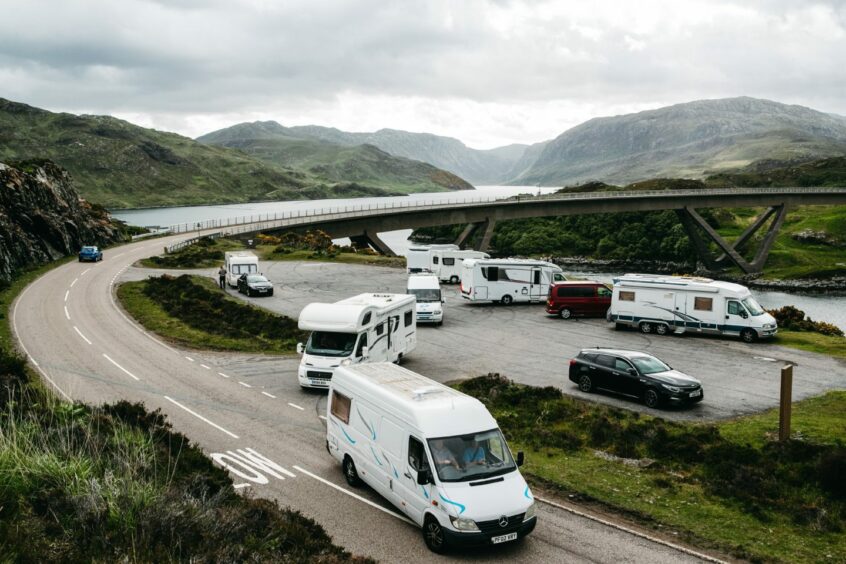 The Kylesku Bridge busy with campervans and traffic.