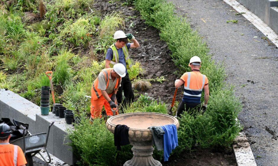Workers in UTG in Aberdeen make progress planting grass up the muddy banks of the gardens. Picture by Paul Glendell/DCT Media.