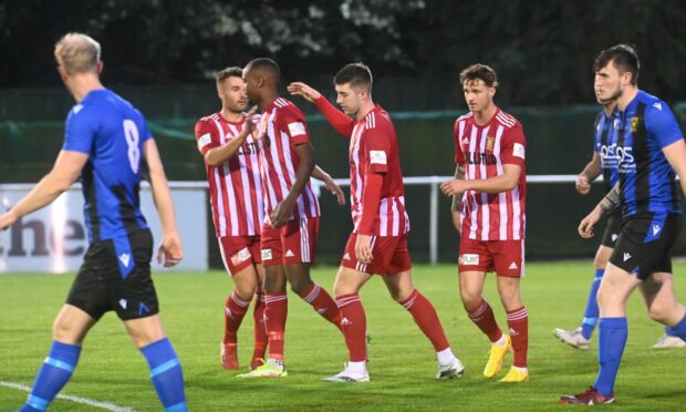 Formartine United players celebrate their goal against Huntly, Julian Wade, pictured second from left in red and white, was the scorer.