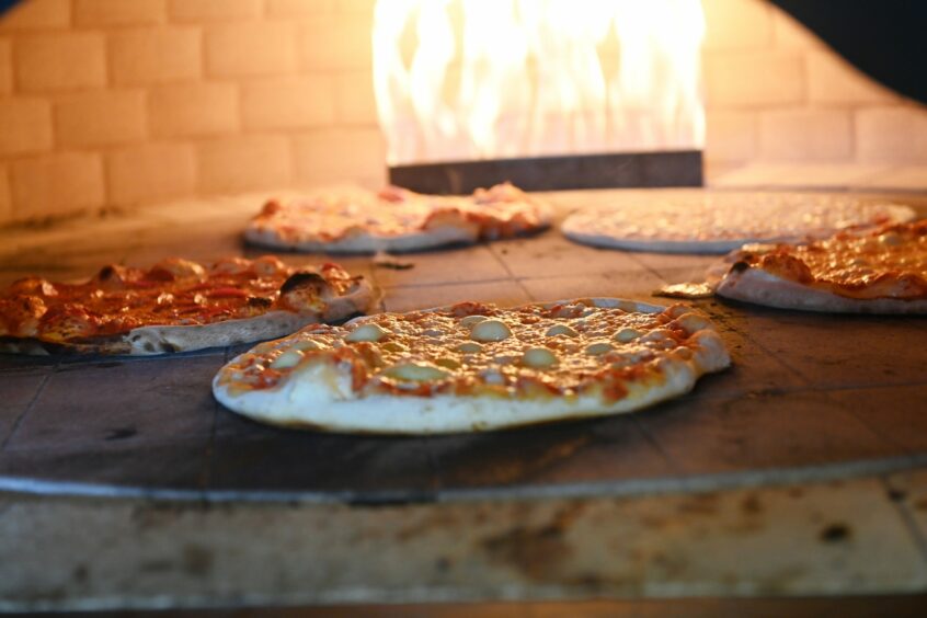 Pizzas cooking in the pizza oven at Fireaway pizza