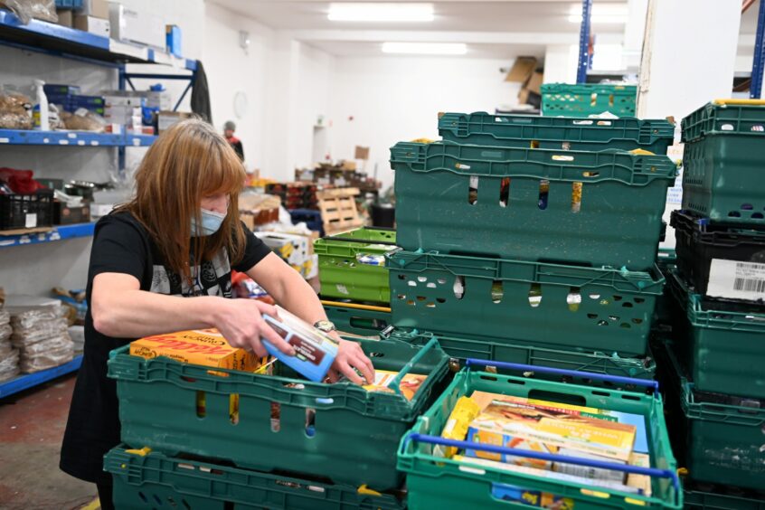 A volunteer makes up food parcels at Cfine in Aberdeen last December. Picture by Paul Glendell/DCT Media.