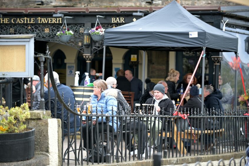 People drinking outside The Castle Tavern pub