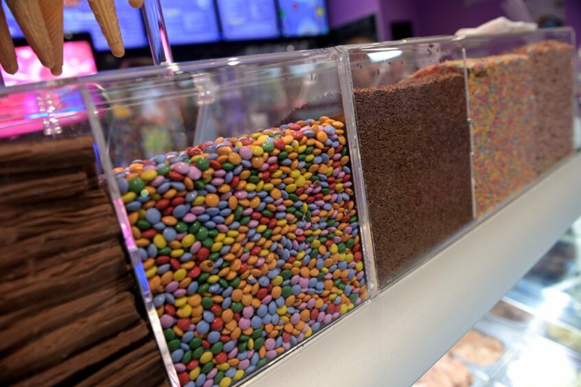 Ice cream toppings in glass cases at Shakes 'n' Cakes Inverness