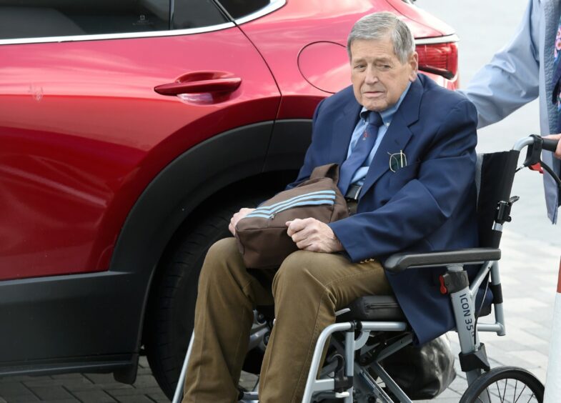 Bill MacDowell looking frail in a wheelchair as he heads into court during his trial. 