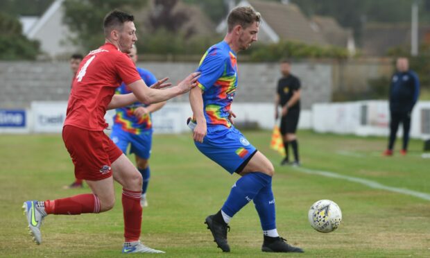 Dean Stewart, left, in action for Lossiemouth against Nairn County