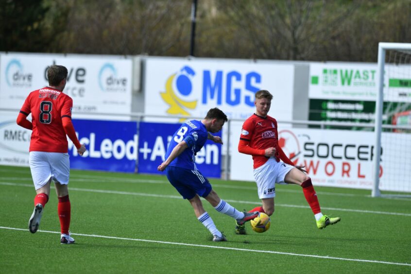 Kyle McClelland, right, attempts to block a shot from Cove Rangers skipper Mitch Megginson during his time with Falkirk