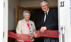Banffshire Lord Lieutenant Andy Simpson cuts the ribbon to officially open the Cullen Heritage Centre with   Cullen, Deskford and Portknockie Heritage Group member Brenda Wood.