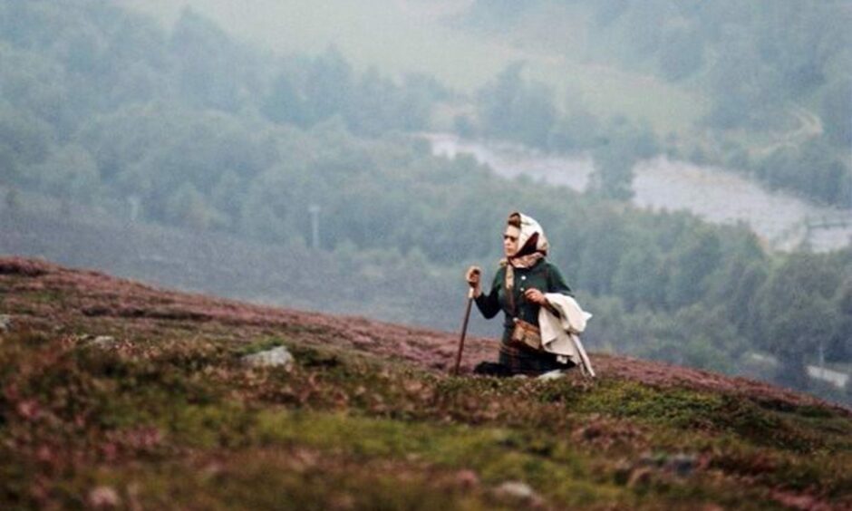 The queen surrounded by the hills of Balmoral