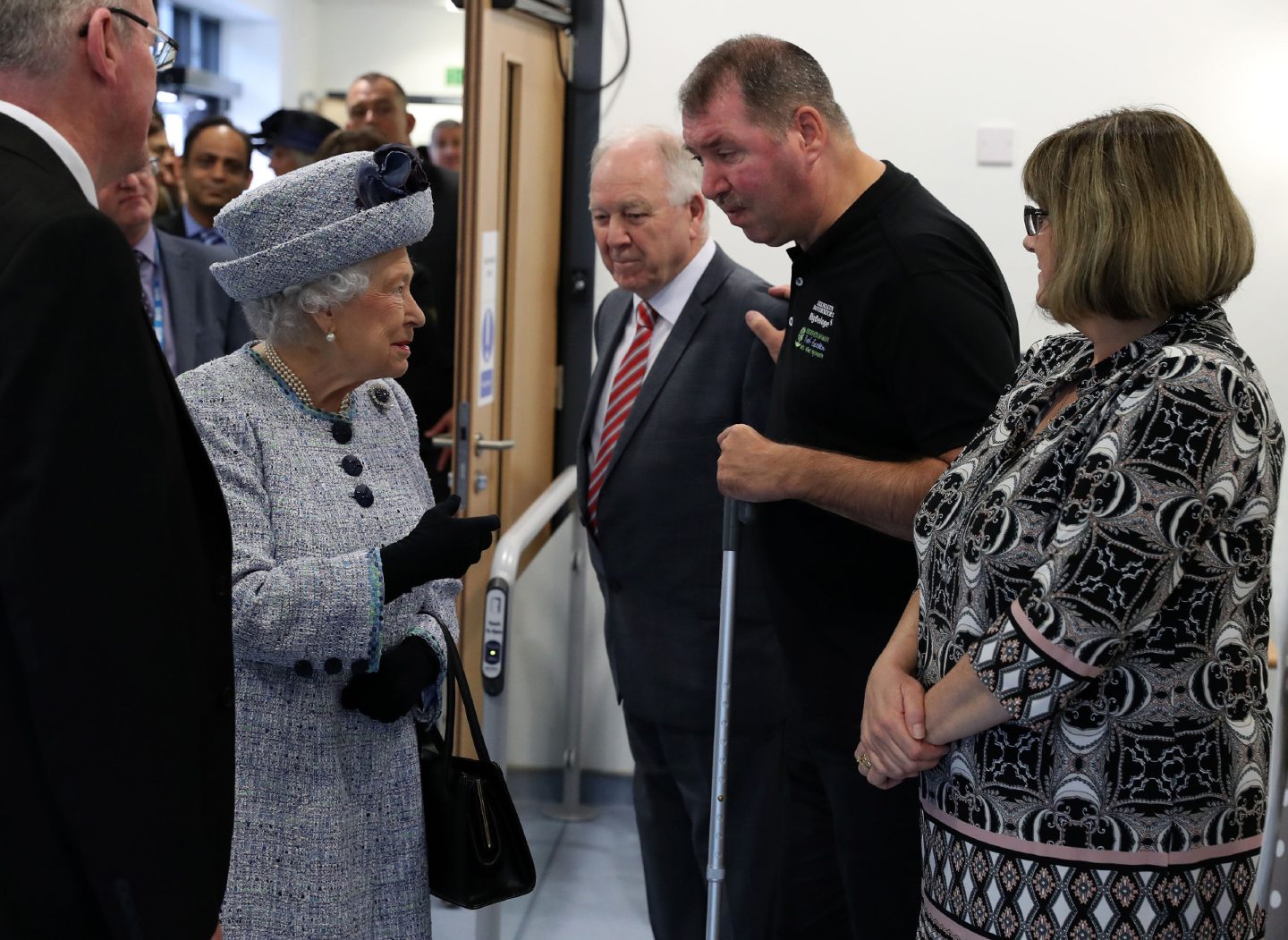 Queen Elizabeth II talks to patient and fundraiser Paul Breen and his wife Liz