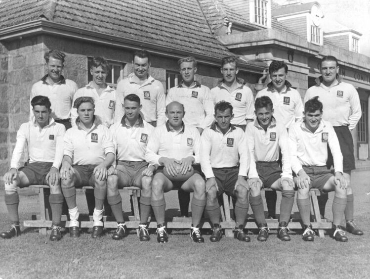 The 1953 Aberdeen Grammar former players club in two lines smiling at the camera