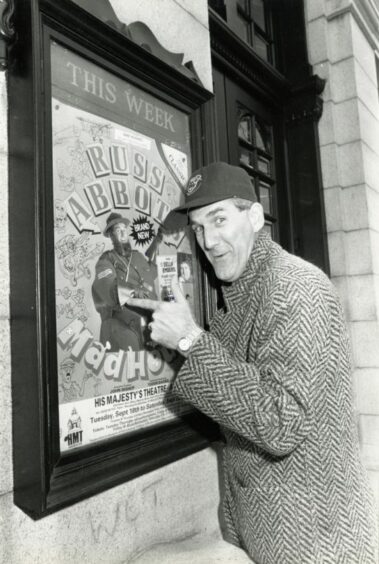 Russ Abbot posing with a poster for his show in September