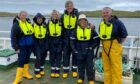 Photo shows a visit to Holms Geo farm in Shetland, hosted by Scottish Sea Farms head of sustainability & development Anne Anderson (far left) and Shetland area manager Robbie Coutts (far right).