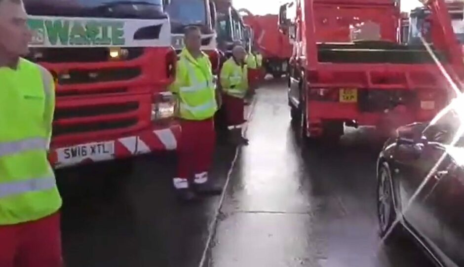 Aberdeen undertakers Dignity Funerals helped organise a special guard of honour involving employees of a skip hire company. Picture shows men lined up next to their vehicles, and the casket on the back of the lorry.