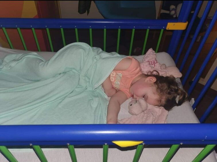 Jessica Davidson sleeping in her crib after suffering coeliac disease symptoms 