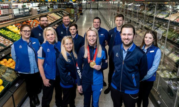 Vicky Wright pictured with Aldi staff at new Aberdeen store. Supplied by Aldi UK