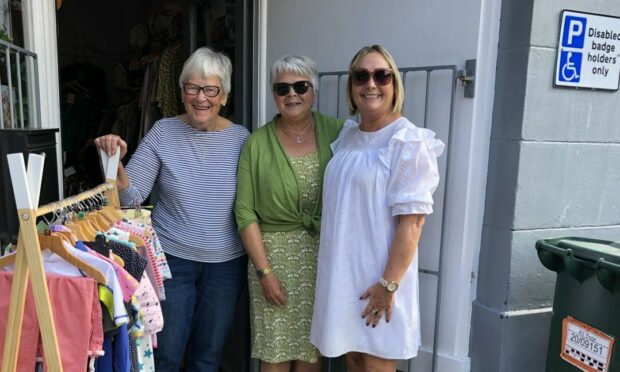 Volunteer Lottie and shop assistants Thelma and Lucy are excited for the new shop to open. Image: Highland Hospice.