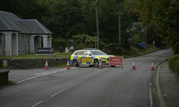 The road remains closed at the site of the crash. Picture by Wullie Marr.