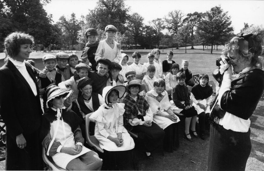 Pupils posing for a photo for the anniversary of Woodside school