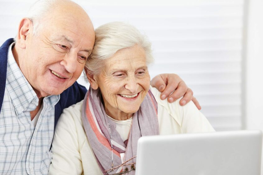 pensioners looking at laptop