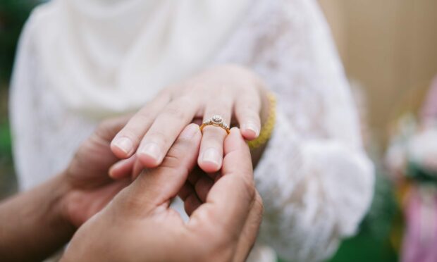 Should a woman automatically change her surname when she says 'I do'? Photo: Shutterstock.