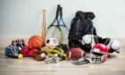 Various different sport kit items such as basketball, tennis racket, baseball bat and bike helmet