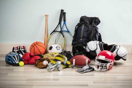 Various different sport kit items such as basketball, tennis racket, baseball bat and bike helmet