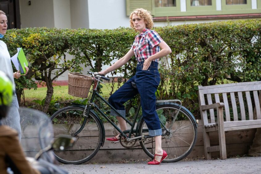 Call the Midwife character cycling on her way to visit patients