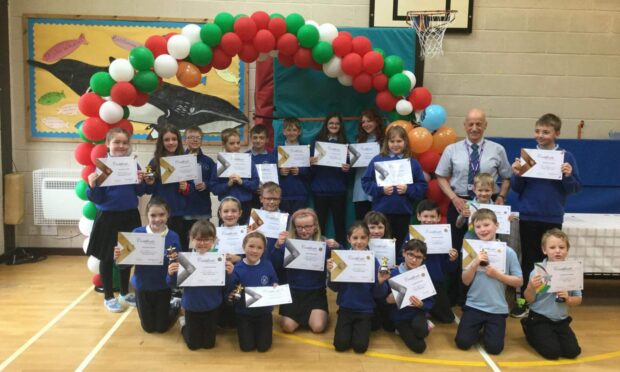 Kyleakin Primary School pupils receive their Junior Duke Award from local councillor John Finlayson.