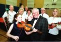 The late Robbie Shepherd with 11-year-old Erin Smith and members of the Aberdeen Strathspey and Reel Society.