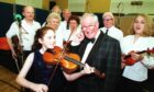 The late Robbie Shepherd with 11-year-old Erin Smith and members of the Aberdeen Strathspey and Reel Society.