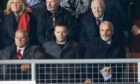 Aberdeen board members and Jim Goodwin watch from the stands at Dundee United.
