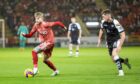 Hayden Coulson on the attack for Aberdeen against Partick Thistle.   Image: Shutterstock.