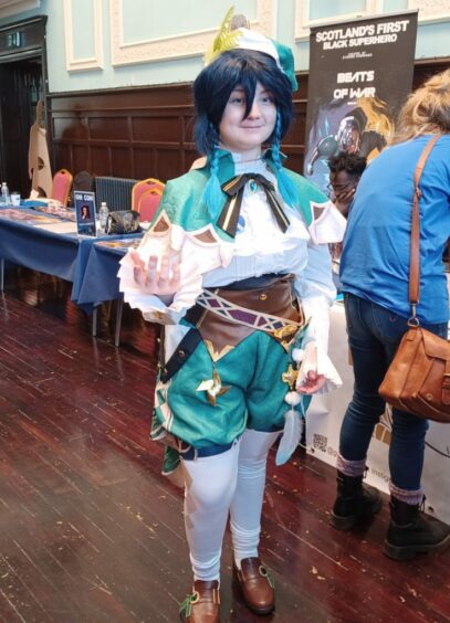 A cosplayer dressed as Venti from Genshin Impact