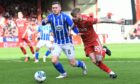 Hayden Coulson drives past Blair Alston of Kilmarnock at Pittodrie. Image: Ross MacDonald / SNS Group