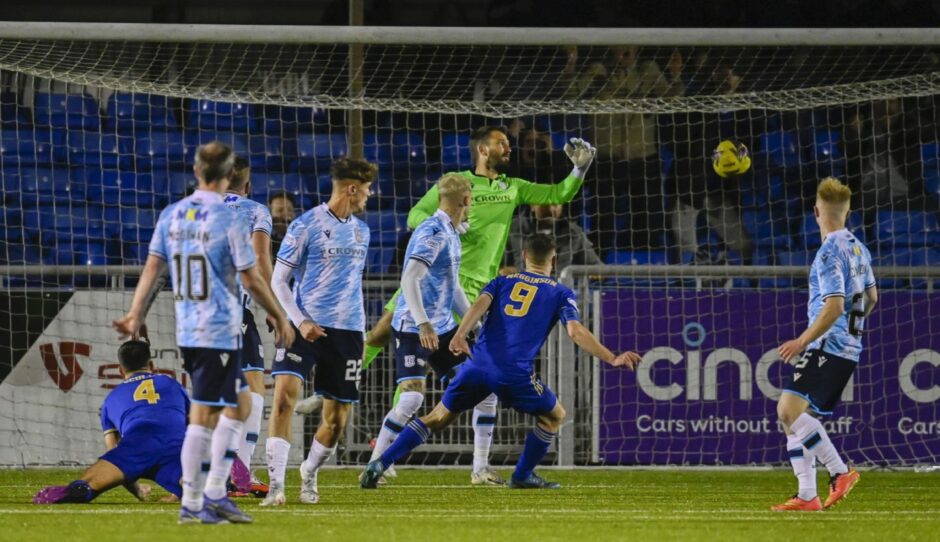 Connor Scully (4) watches on as his overhead kick puts Cove Rangers 3-1 in front against Dundee. Image: SNS