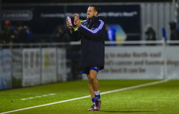 Connor Scully applauds the Cove Rangers fans at full-time. Image: SNS