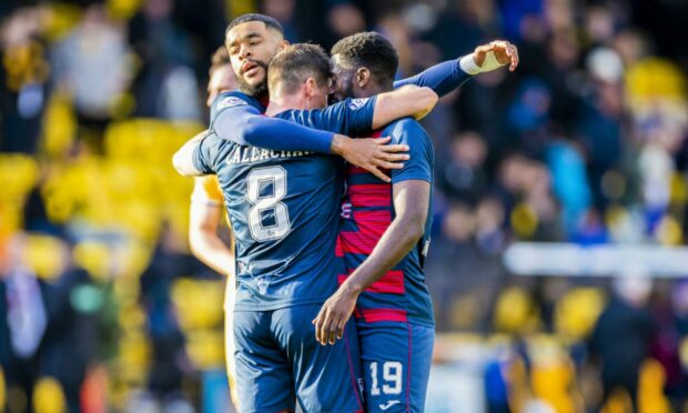 Jordy Hiwula (right) celebrates Ross County's win over Livingston with Ross Callachan and Dominic Samuel.