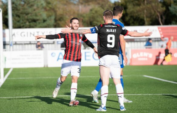 Steven Boyd is congratulated by Billy Mckay after his goal for Caley Thistle against Cove Rangers. Image: SNS