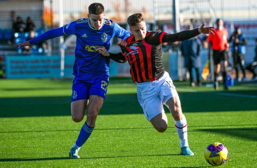 Cove Rangers defender Max Johnston gets to grips with Caley Thistle's Daniel MacKay. Image: SNS