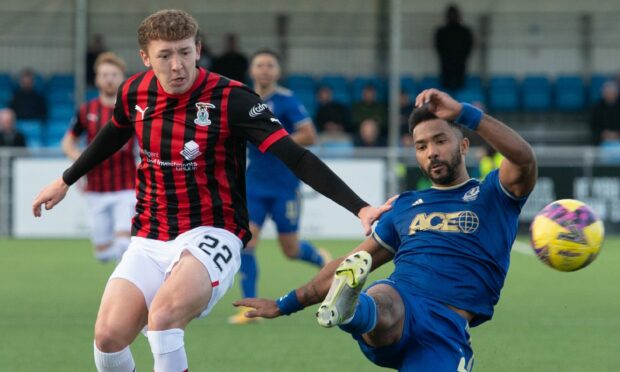 Shay Logan takes the ball away from Caley Thistle's Nathan Shaw. Image: SNS