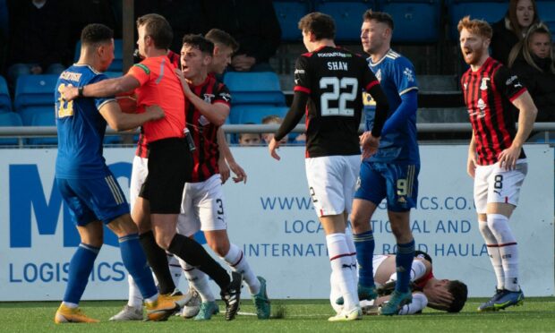 Leighton McIntosh, left, is sent off for Cove Rangers against Caley Thistle after lashing out at Zak Delaney. Image: SNS