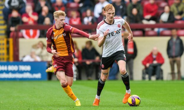 Aberdeens Liam Scales and Motherwell's Stuart McKinstry at Fir Park. Image: SNS