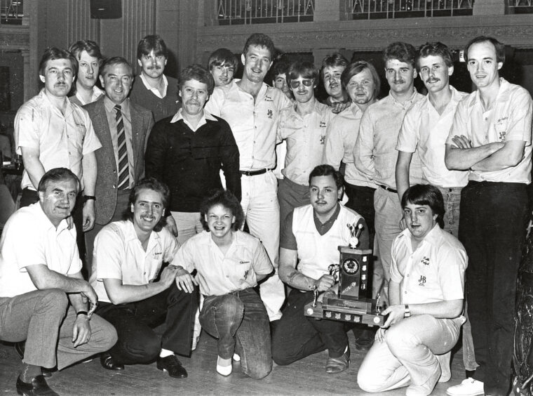 A large group of Aberdeen darts players gathered around the Evening Express Trophy.